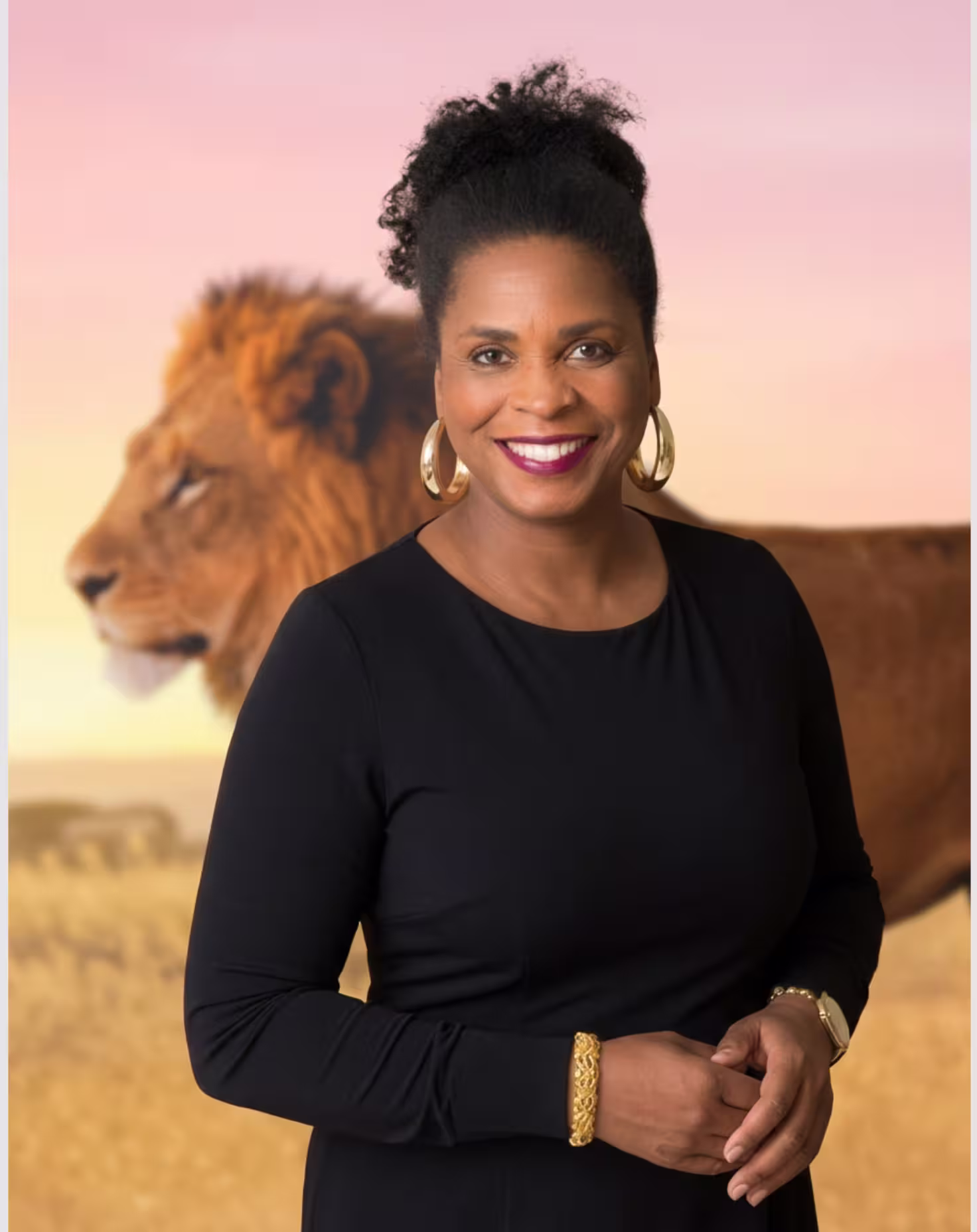 Leonie Noble-Dawkins posing for her one-on-one consultation, wearing a stunning black dress, with a wallpaper of a majestic lion behind her.